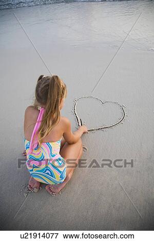 Girl drawing heart in sand, Florida, United States View Large Photo Image Stock Photo - Girl drawing heart in sand, Florida, United States. Fotosearch