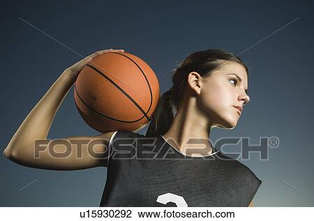 Stock Image - Girl holding basketball. Fotosearch