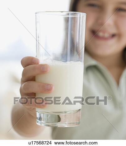 Picture - Girl holding glass of milk. Fotosearch