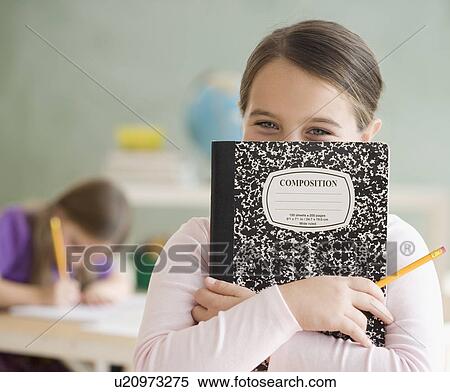 Stock Photography - Girl holding notebook in front of face. Fotosearch