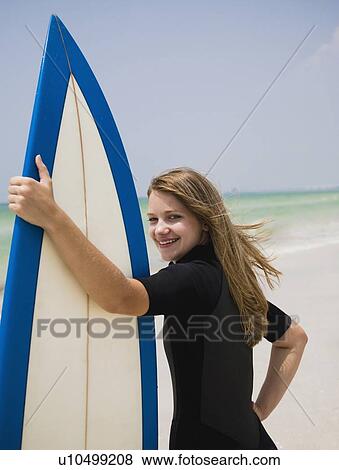 Girl holding surfboard, Florida, United States View Large Photo Image Stock Photo - Girl holding surfboard, Florida, United States. Fotosearch