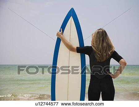 Stock Photo - Girl holding surfboard, Florida, United States. Fotosearch
