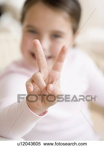 Girl holding up two fingers View Large Photo Image Stock Photography - Girl holding up two fingers. Fotosearch