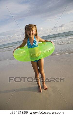 Girl in inner tube at beach, Florida, United States View Large Photo Image Stock Photo - Girl in inner tube at beach, Florida, United States. Fotosearch