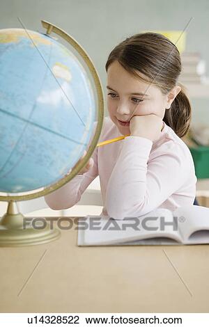 Girl looking at globe in classroom View Large Photo Image Stock Image - Girl looking at globe in classroom. Fotosearch