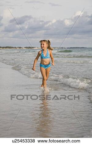 Girl running in ocean surf, Florida, United States View Large Photo Image Stock Photo - Girl running in ocean surf, Florida, United States. Fotosearch