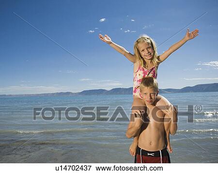 Girl sitting on brother’s shoulders, Utah, United States View Large Photo Image Stock Photo - Girl sitting on brother’s shoulders, Utah, United States. Fotosearch