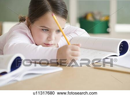 Stock Image - Girl studying in classroom. Fotosearch