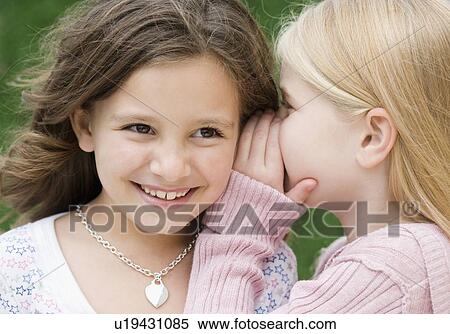 Stock Photography - Girl telling secret. Fotosearch