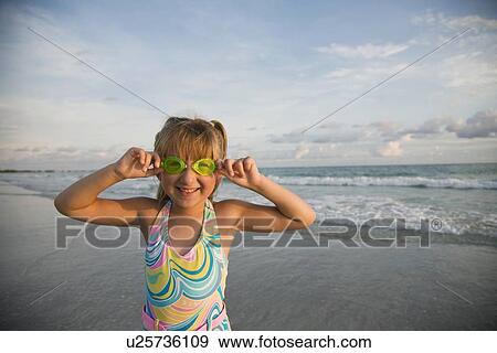 Stock Photo - Girl wearing goggles at beach, Florida, United States. Fotosearch