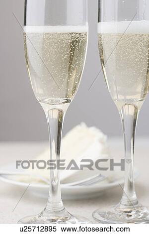 Glasses of champagne with white cake View Large Photo Image Stock Photography - Glasses of champagne with white cake. Fotosearch