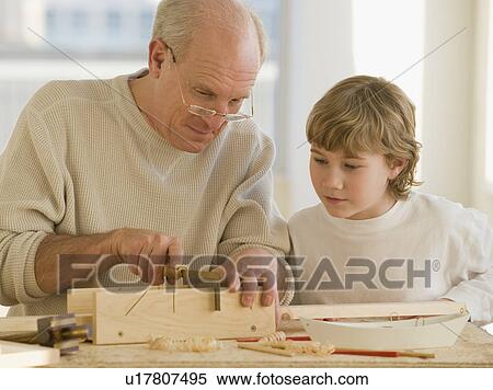 Grandfather and grandson woodworking View Large Photo Image Stock Photography - Grandfather and grandson woodworking. Fotosearch