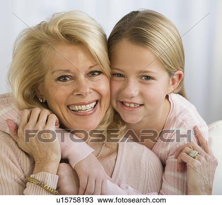 Stock Image - Grandmother and granddaughter hugging. Fotosearch
