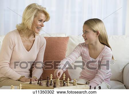 Grandmother and granddaughter playing chess View Large Photo Image Stock Image - Grandmother and granddaughter playing chess. Fotosearch