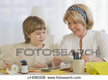 Grandmother and grandson scrapbooking View Large Photo Image Stock Photo - Grandmother and grandson scrapbooking. Fotosearch