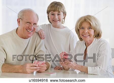 Grandson watching grandparents play cards View Large Photo Image Stock Photograph - Grandson watching grandparents play cards. Fotosearch