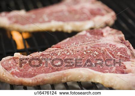 Grilling steaks outdoors View Large Photo Image Picture - Grilling steaks outdoors. Fotosearch