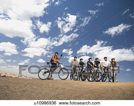 Group of cyclists in desert View Large Photo Image Stock Photograph - Group of cyclists in desert. Fotosearch