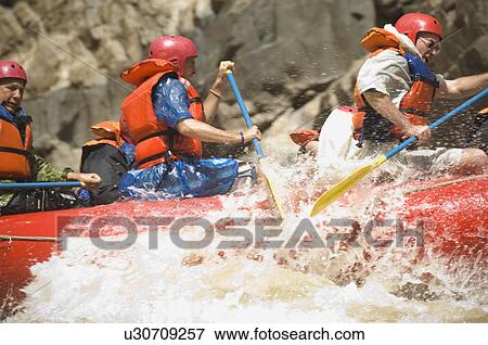 Stock Photo - Group of people river rafting. Fotosearch