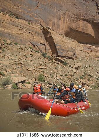Stock Photograph - Group of people river rafting. Fotosearch
