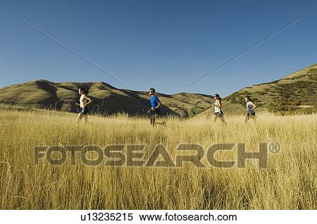Group of people running in field, Utah, United States View Large Photo Image Stock Photography - Group of people running in field, Utah, United States. Fotosearch