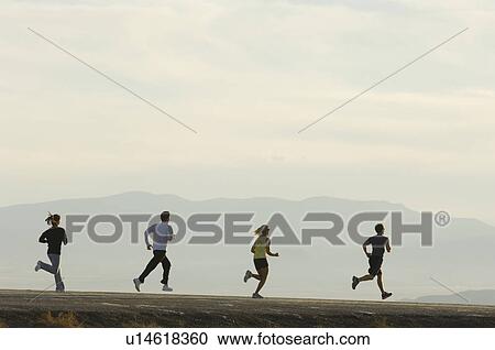 Group of people running on road, Utah, United States View Large Photo Image Stock Image - Group of people running on road, Utah, United States. Fotosearch