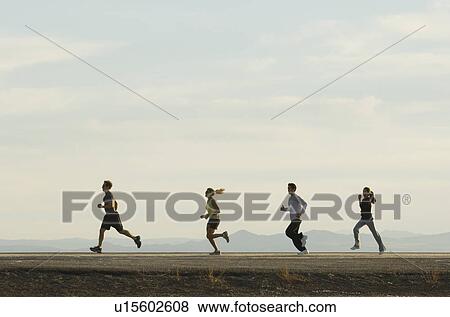 Group of people running on road, Utah, United States View Large Photo Image Stock Photo - Group of people running on road, Utah, United States. Fotosearch