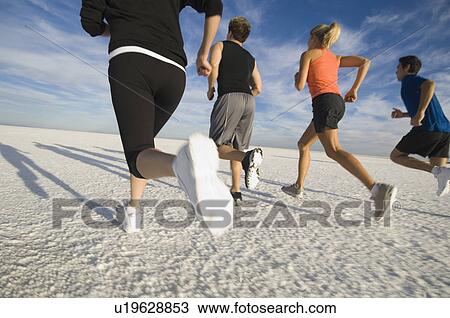 Group of people running on salt flats, Utah, United States View Large Photo Image Stock Image - Group of people running on salt flats, Utah, United States. Fotosearch