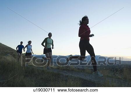 Stock Image - Group of people running on trail, Salt Flats, Utah, United States. Fotosearch