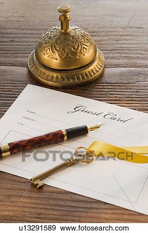 Guest registry card, pen, key and bell on table View Large Photo Image Stock Photo - Guest registry card, pen, key and bell on table. Fotosearch
