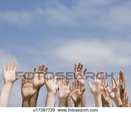 Stock Photo - Hands raised under blue sky. Fotosearch