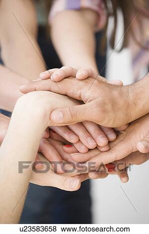 Stock Photo - Hands stacked on top of each other. Fotosearch