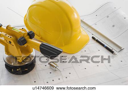 Hard hat and surveying equipment on blueprints View Large Photo Image Stock Photo - Hard hat and surveying equipment on blueprints. Fotosearch
