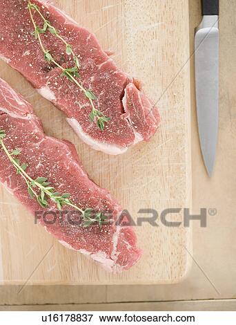 High angle view of meat and spices on cutting board View Large Photo Image Stock Photo - High angle view of meat and spices on cutting board. Fotosearch