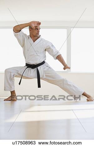 Hispanic male karate black belt in fighting stance View Large Photo Image Stock Image - Hispanic male karate black belt in fighting stance. Fotosearch
