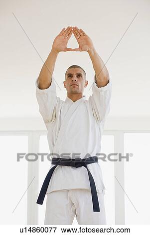 Stock Photo - Hispanic male karate black belt in stance. Fotosearch