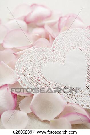 Stock Photo - Lacy heart with rose petals. Fotosearch