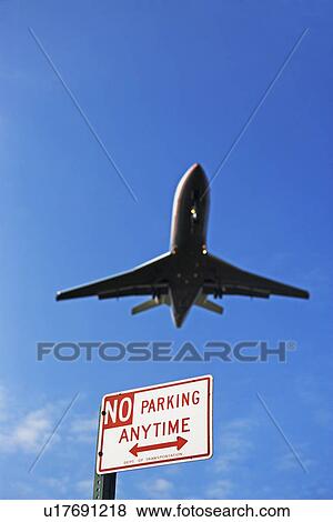 Low angle view of airplane in flight View Large Photo Image Stock Photo - Low angle view of airplane in flight. Fotosearch