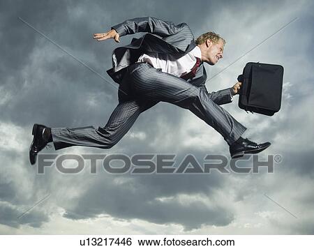 Low angle view of businessman jumping View Large Photo Image Stock Photograph - Low angle view of businessman jumping. Fotosearch