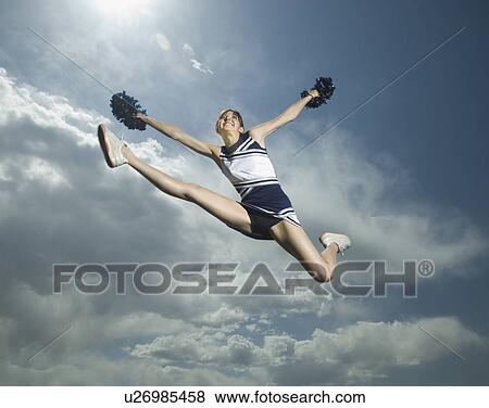 Low angle view of cheerleader jumping View Large Photo Image Stock Photo - Low angle view of cheerleader jumping. Fotosearch