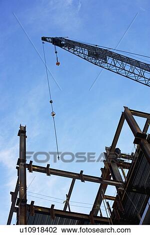Low angle view of construction site and crane View Large Photo Image Stock Image - Low angle view of construction site and crane. Fotosearch