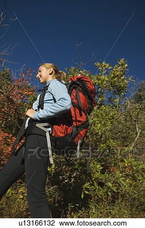 Low angle view of female hiker, Utah, United States View Large Photo Image Stock Image - Low angle view of female hiker, Utah, United States. Fotosearch