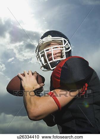 Low angle view of football player View Large Photo Image Stock Image - Low angle view of football player. Fotosearch