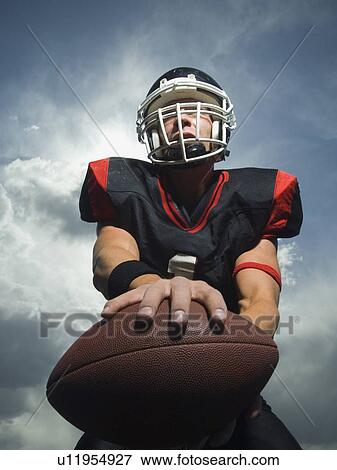 Stock Photo - Low angle view of football player. Fotosearch