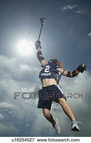 Stock Photo - Low angle view of jai-alai player jumping. Fotosearch