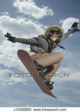 Low angle view of snowboarder jumping View Large Photo Image Stock Image - Low angle view of snowboarder jumping. Fotosearch