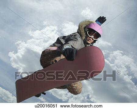 Low angle view of snowboarder jumping View Large Photo Image Stock Image - Low angle view of snowboarder jumping. Fotosearch