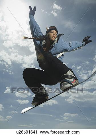 Low angle view of snowboarder jumping View Large Photo Image Stock Image - Low angle view of snowboarder jumping. Fotosearch