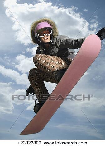 Low angle view of snowboarder jumping View Large Photo Image Stock Photo - Low angle view of snowboarder jumping. Fotosearch