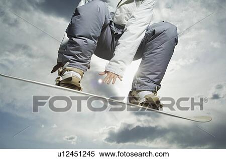 Low angle view of snowboarder View Large Photo Image Stock Photography - Low angle view of snowboarder. Fotosearch